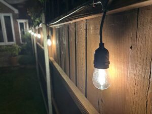 Professional outdoor lighting installation by Sunrise Electrical in Gloucester, Gloucestershire, illuminating a garden and patio area.