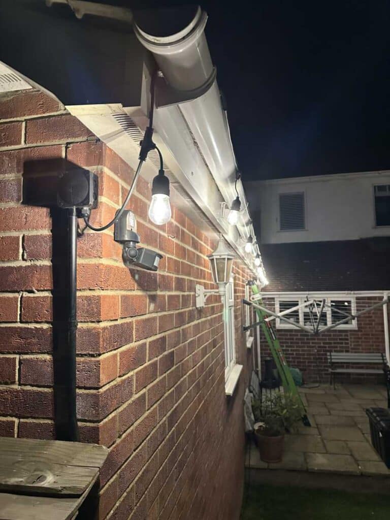 Professional outdoor lighting installation by Sunrise Electrical in Gloucester, Gloucestershire, illuminating a garden and patio area.