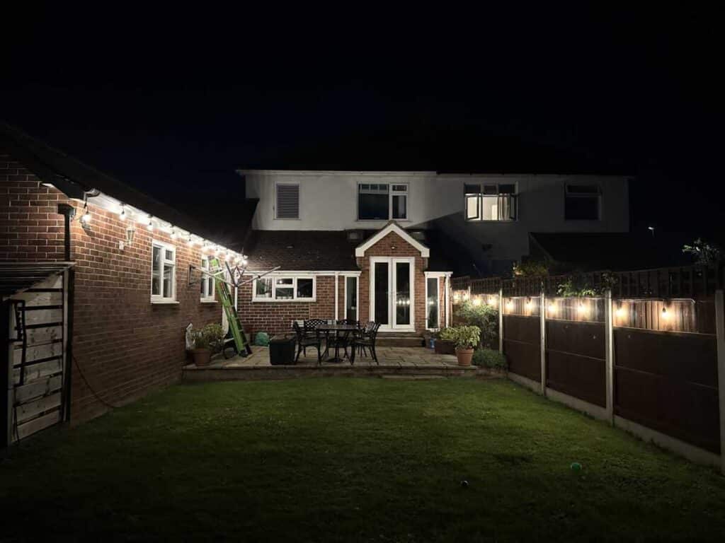 Professional outdoor lighting installation by Sunrise Electrical in Gloucester, Gloucestershire, illuminating a garden and patio area.